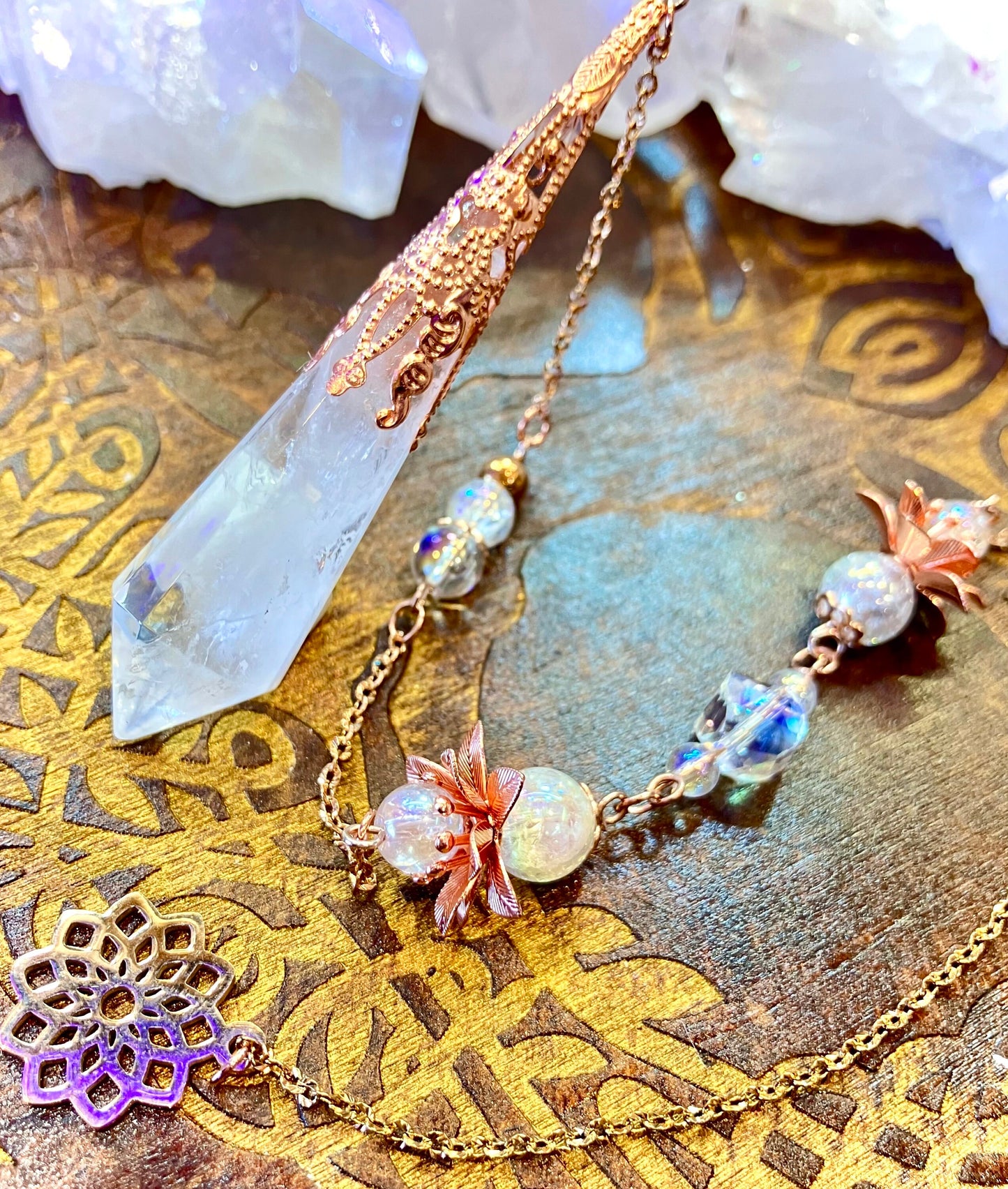 Crystal and aura quartz pendulum with cracked angel flower