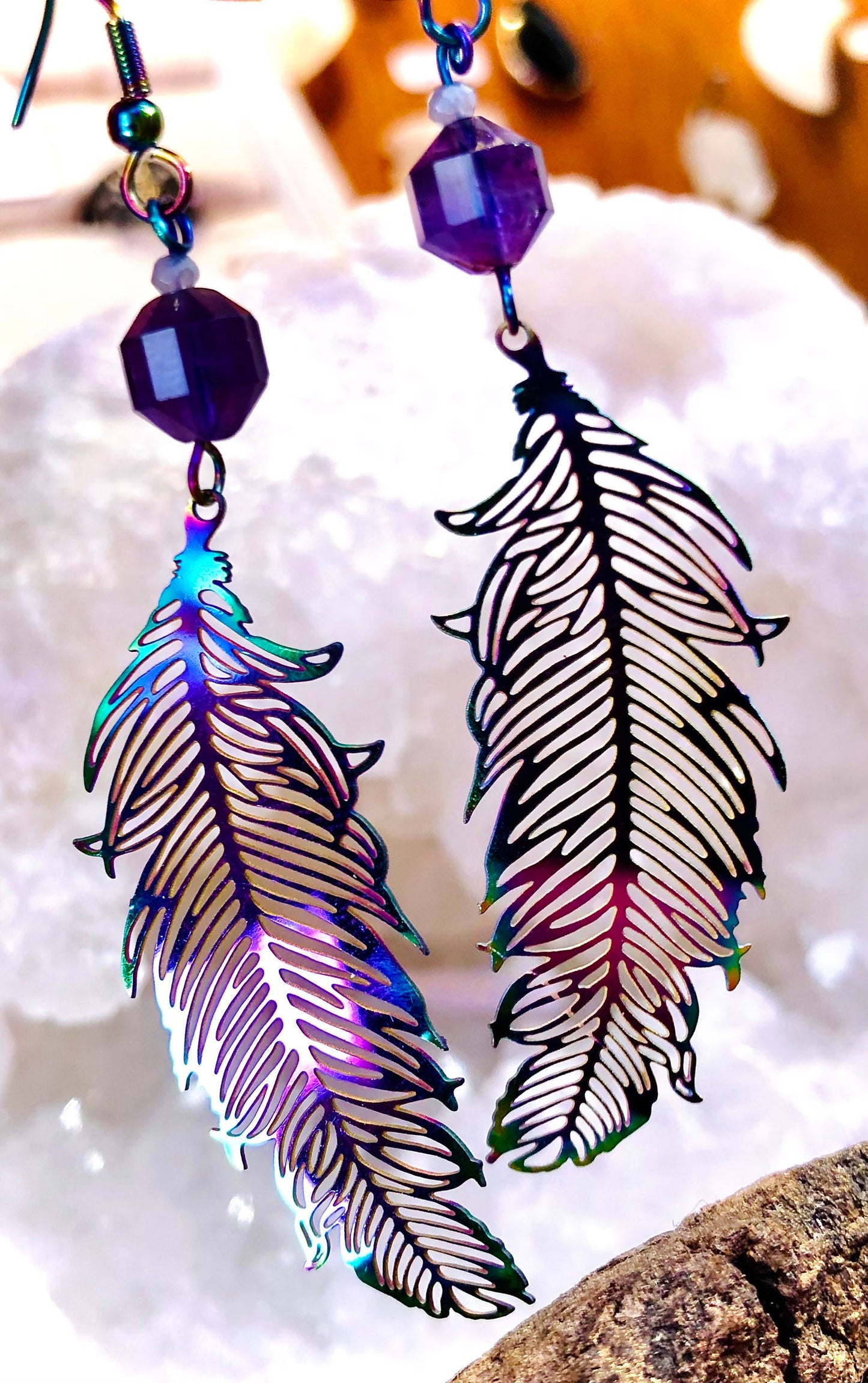 Filigree feather earring in iridescent metal and faceted amethyst