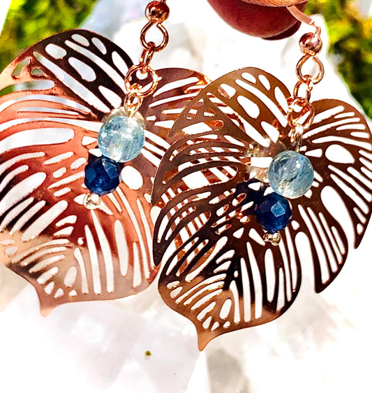 Rose gold filigree metal leaf earring with faceted blue sapphire and fluorapatite