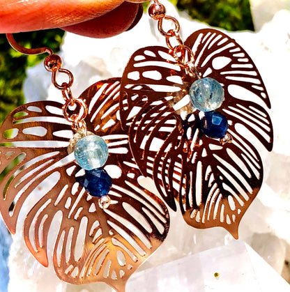 Rose gold filigree metal leaf earring with faceted blue sapphire and fluorapatite